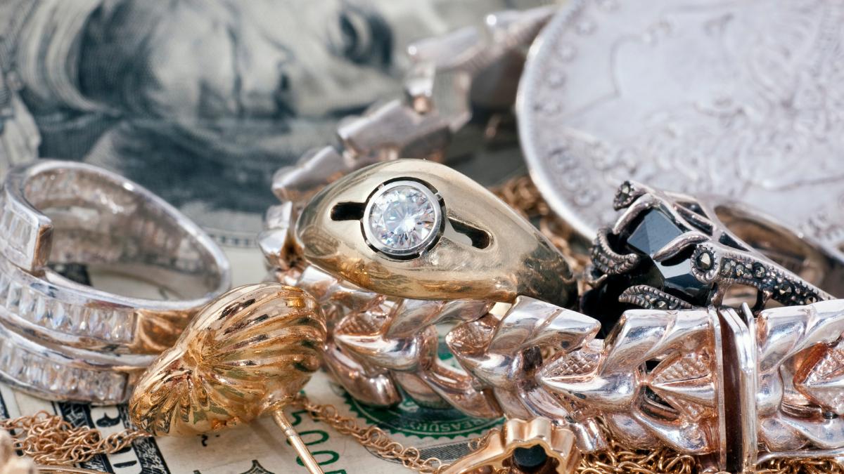 Gold and silver coins being valued in Charlotte, NC by Let Go Liquidation